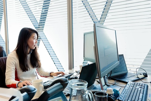 Image of women on her desktop in the workplace 