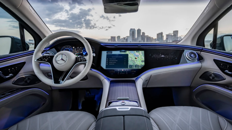Mercedes-Benz car interior showing the cockpit with MBUX Voice Assistant appearing on cockpit screen