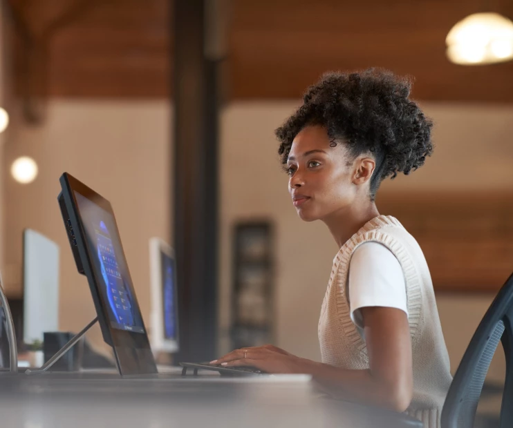 a person sitting at a desk using a computer