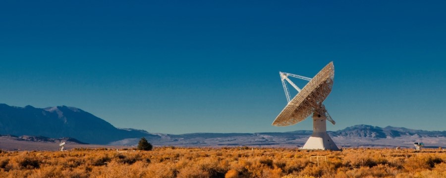 a satellite dish in the desert.
