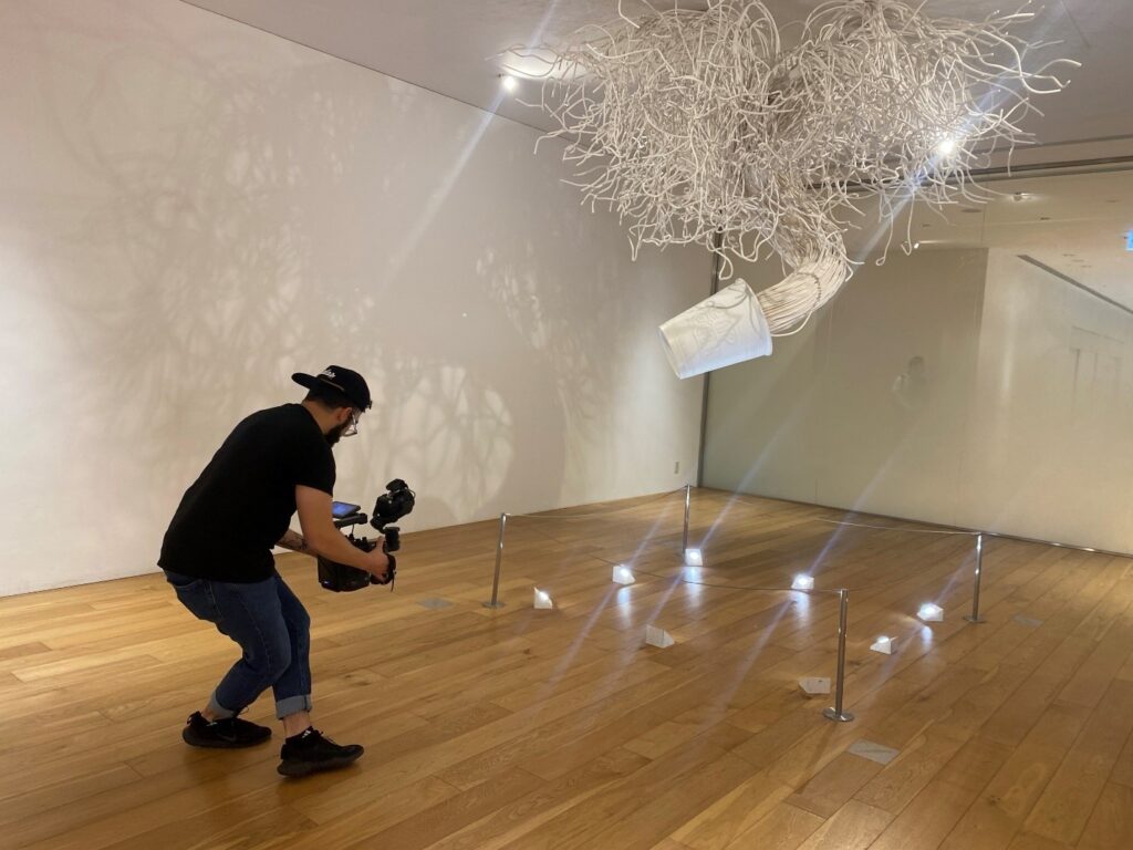 Videographer capturing footage of an art installation