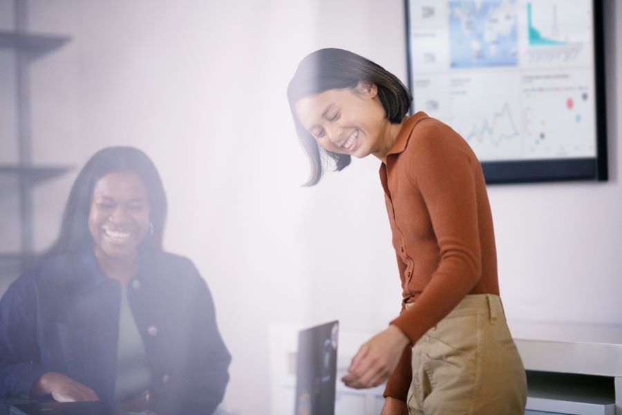 Two women working over a computer