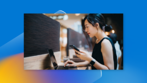 Person using a laptop and phone simultaneously