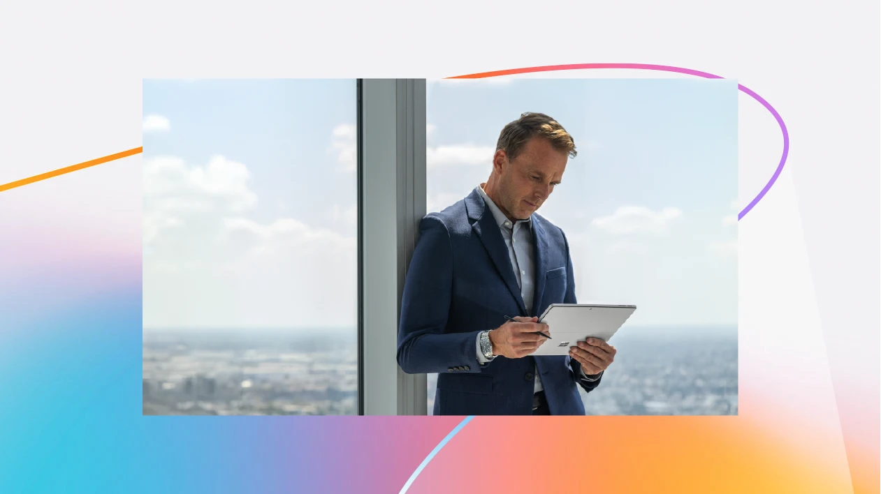 A man in a suit holding a tablet
