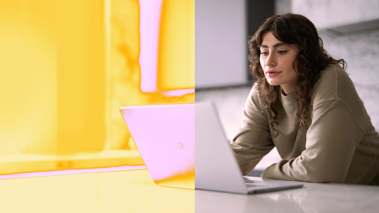A woman sitting at a table with a laptop