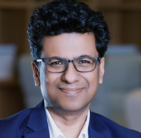 A man wearing glasses and a suit
