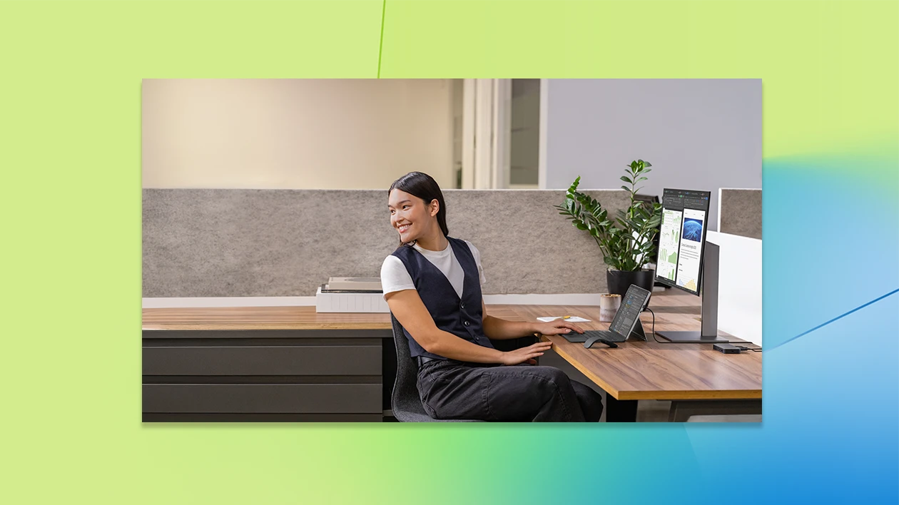 A woman sitting at a desk with a computer