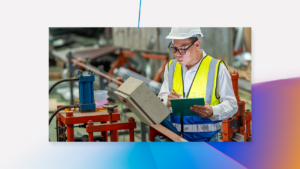 Engineer uses a digital tablet as he inspects machinery in a factory.