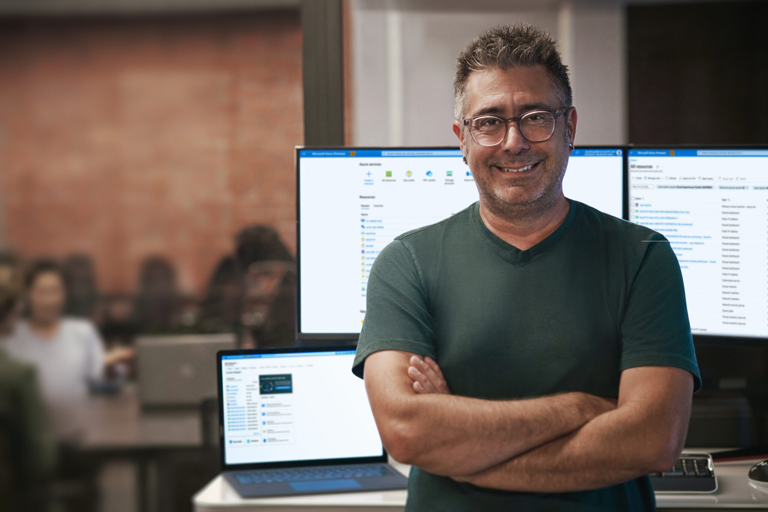 Person standing in front of monitors.