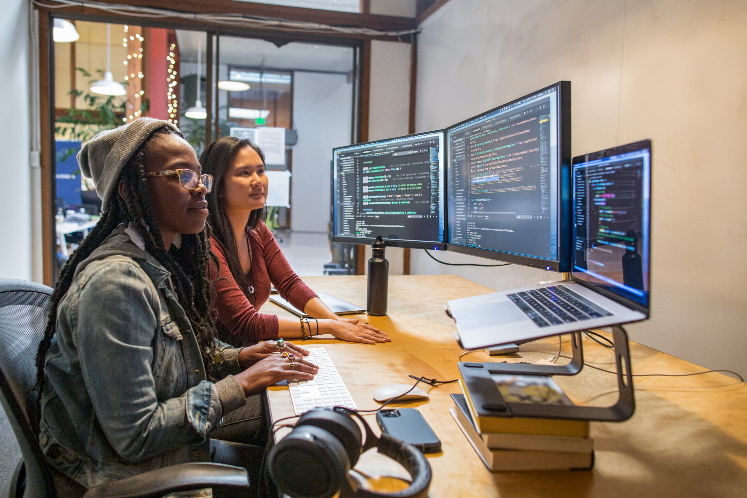 2 People sitting in front of computers