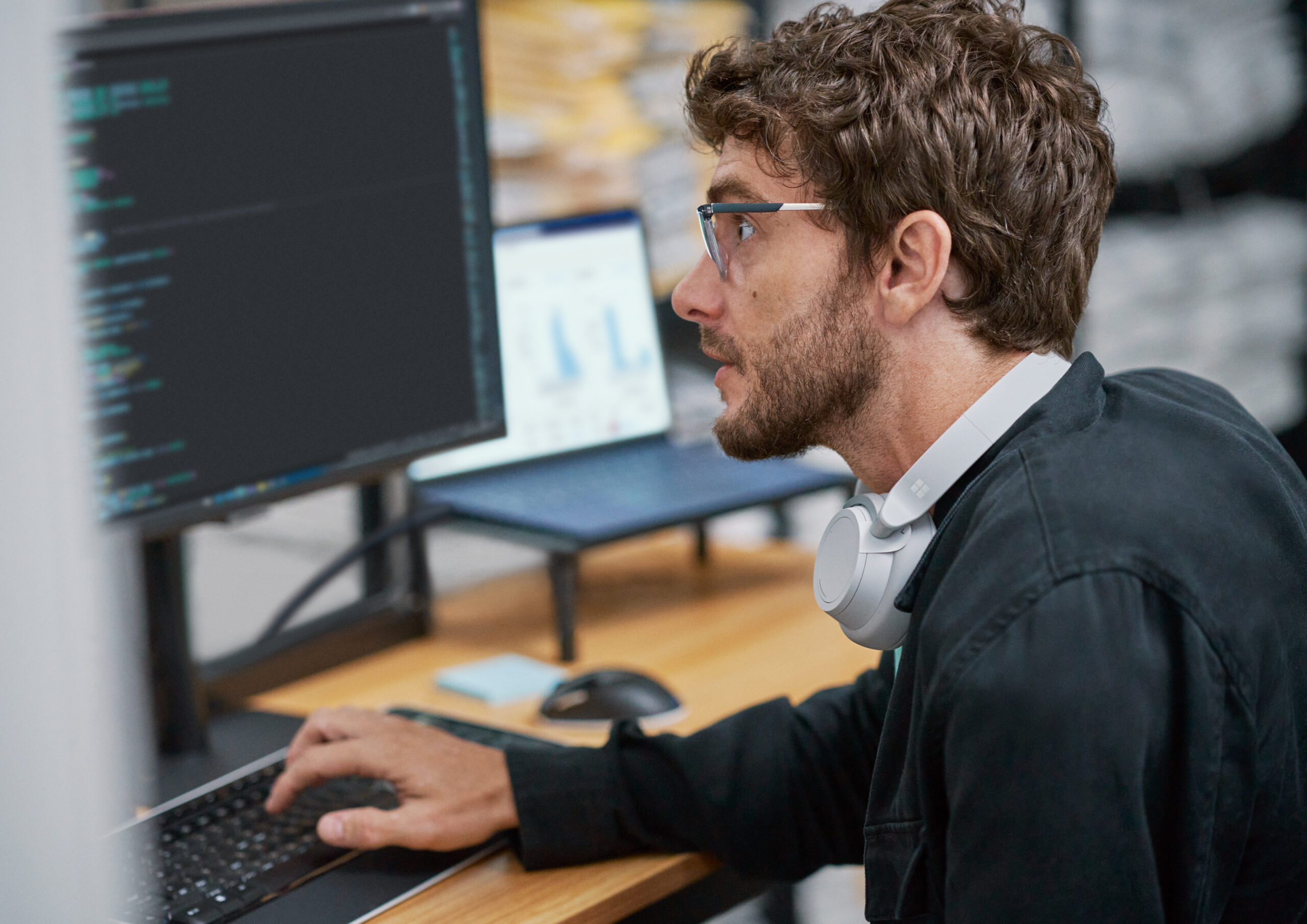 Person sitting at desk and working at computer.