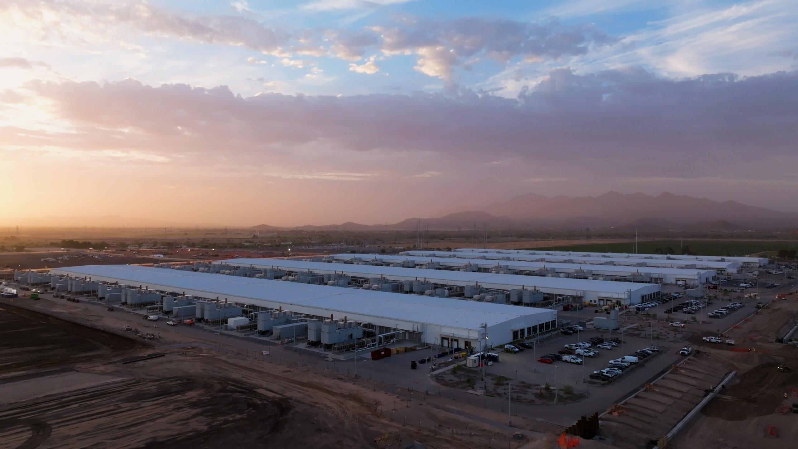 A datacenter with a sunset sky overhead