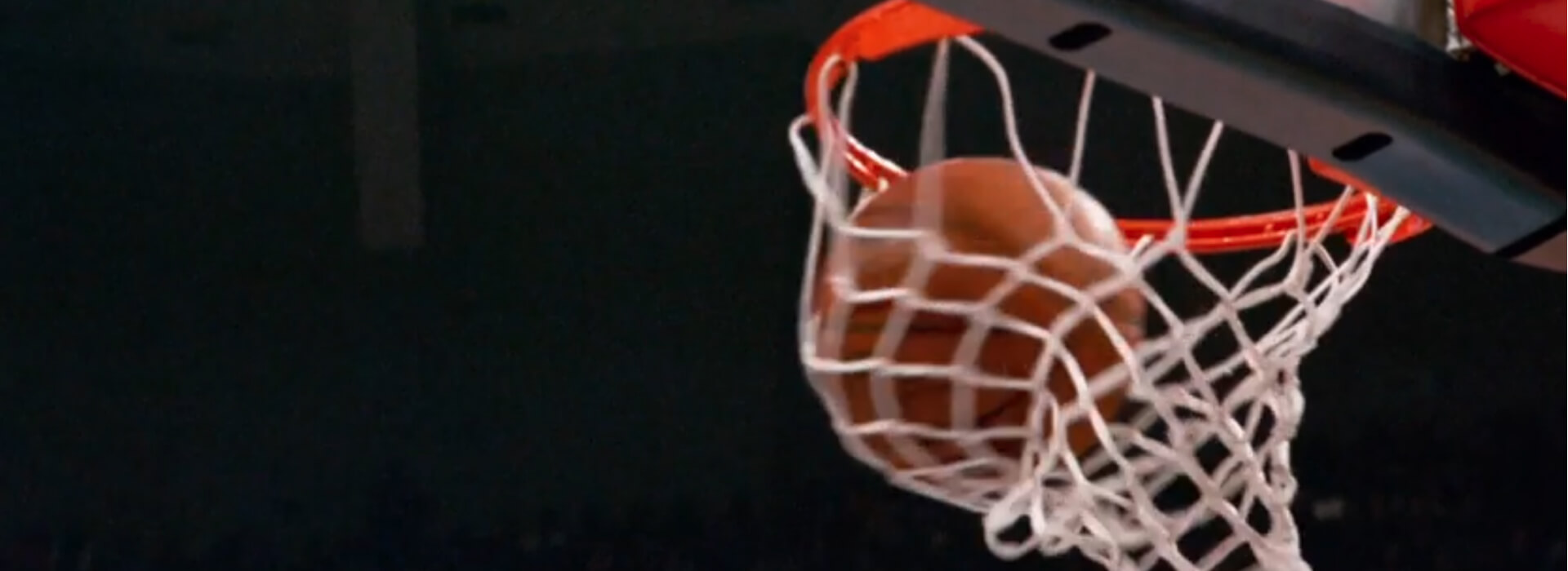 Balón de baloncesto entrando por el aro.